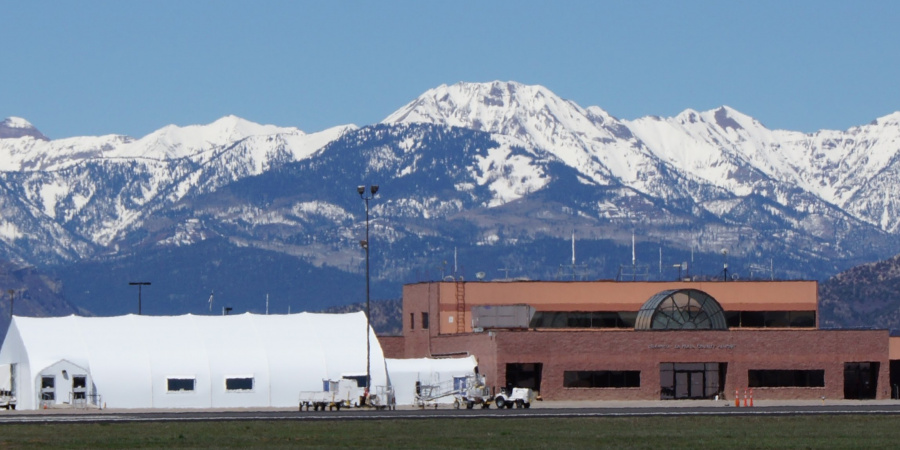 Durango Airport buildings with the snow-capped La Plata mountain range in the distance.